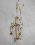 Brass shower system mounted on a gray marble wall