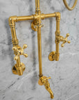 Brass shower system mounted on a gray marble wall