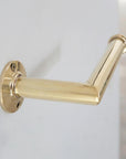 Brass towel holder on a white wall