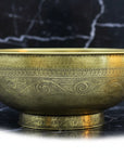 Decorative Bronze drop in sink on a black marble surface
