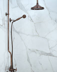 Vintage-style bronze shower head and control panel on a white background
