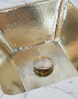 Close-up of a brass hammered sink