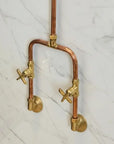 Brass and copper faucet on a marble wall