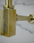 Solid Brass Bathroom Sink P-Trap mounted on a white wall