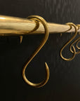 Brass hooks on a black background