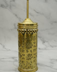 Decorative gold container with intricate patterns on a marble surface