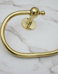 Gold towel ring on a gray textured surface