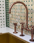 Copper kitchen faucet and handles on a tiled wall background