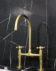 Gold faucet on a black marble wall