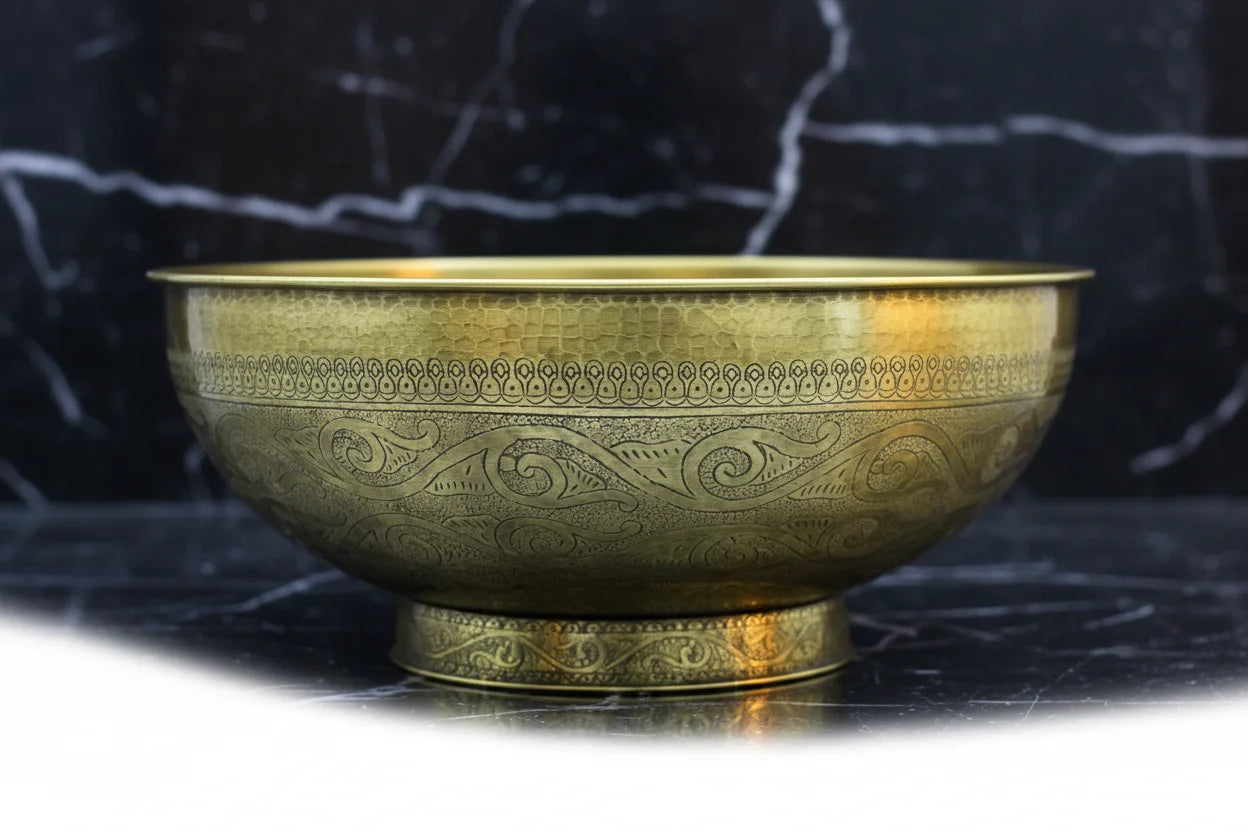 Decorative Bronze drop in sink on a black marble surface