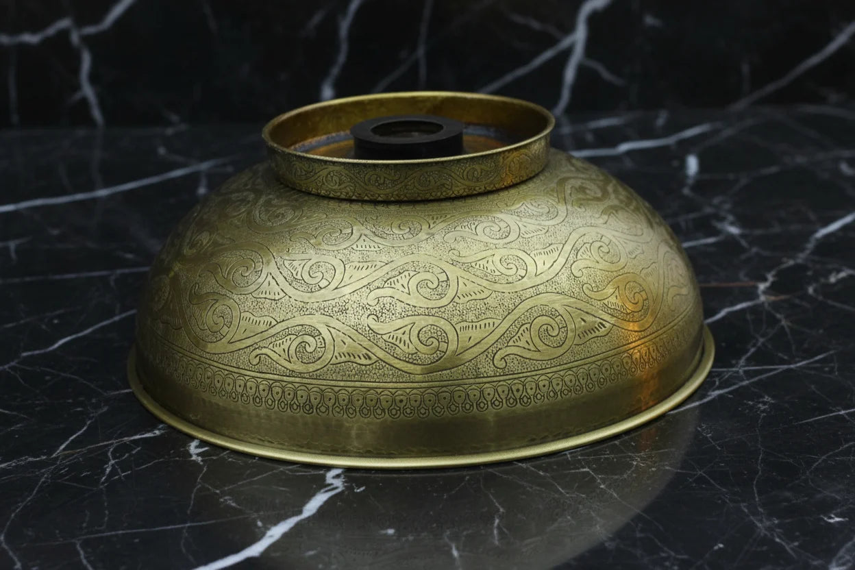 Decorative Bronze drop in sink on a black marble surface
