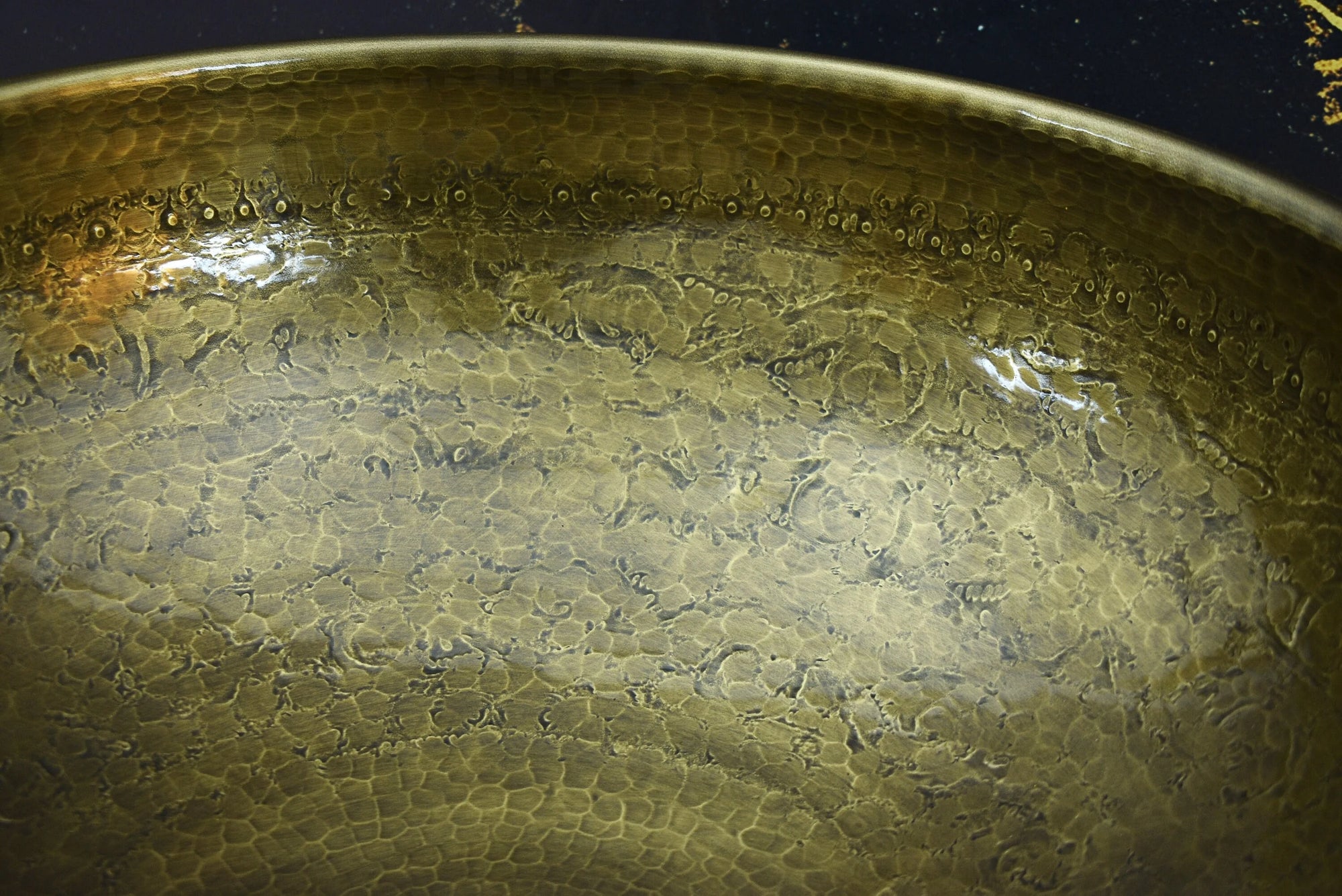 Close-up of a textured bronze or copper surface