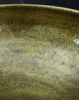 Close-up of a textured bronze or copper surface