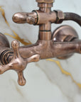 Close-up of a copper faucet with a hose on a light gray background