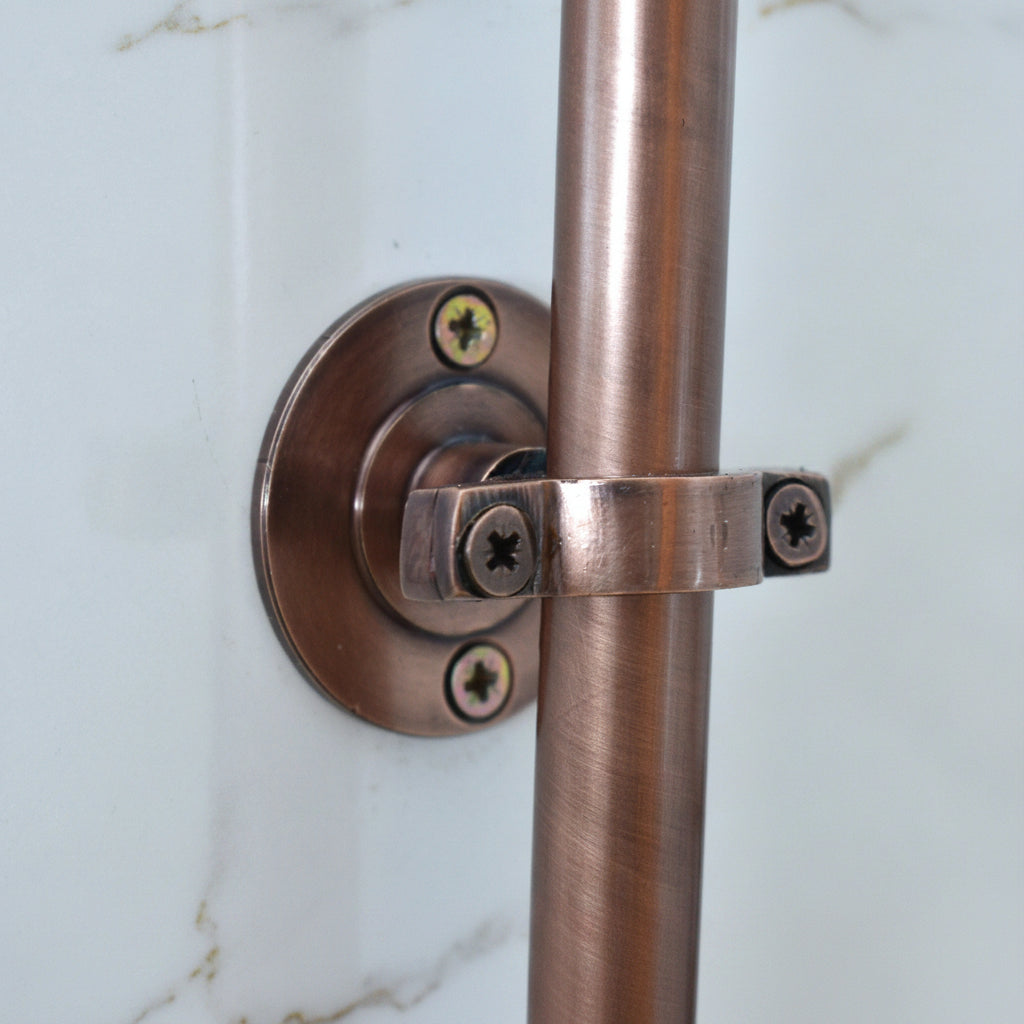 Copper towel bar with bracket on a white background