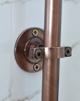 Copper towel bar with bracket on a white background