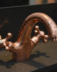brass faucet on a dark surface