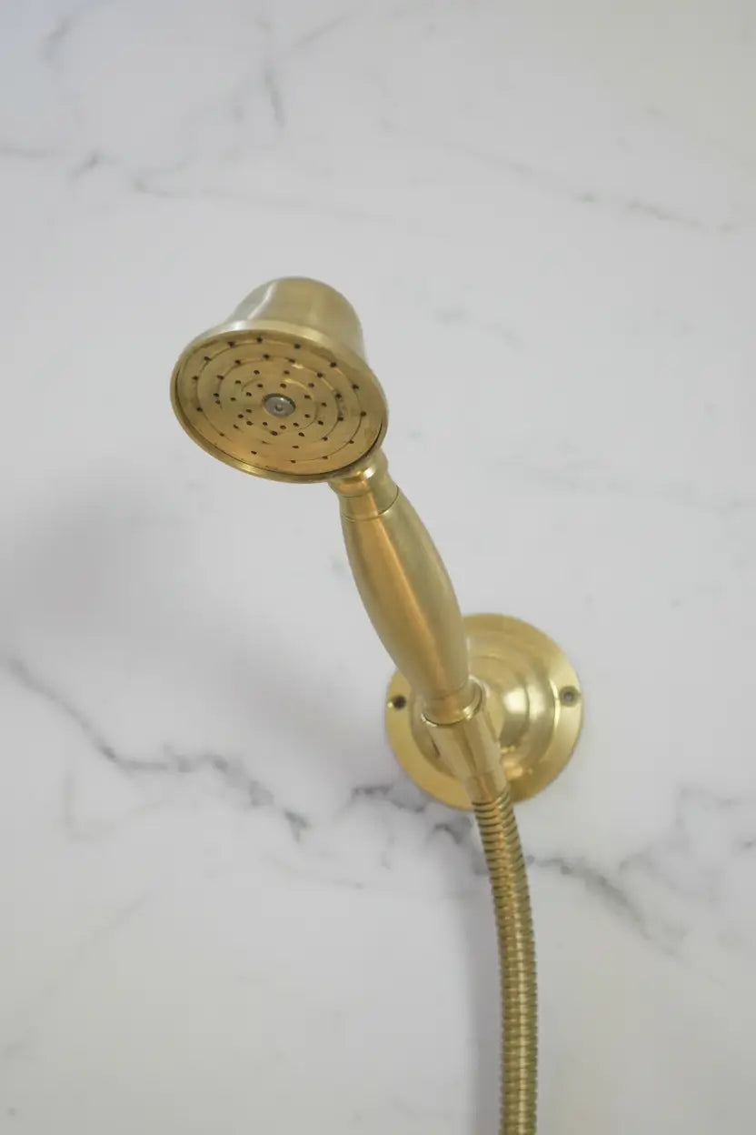 Gold shower head and hose on a marble background