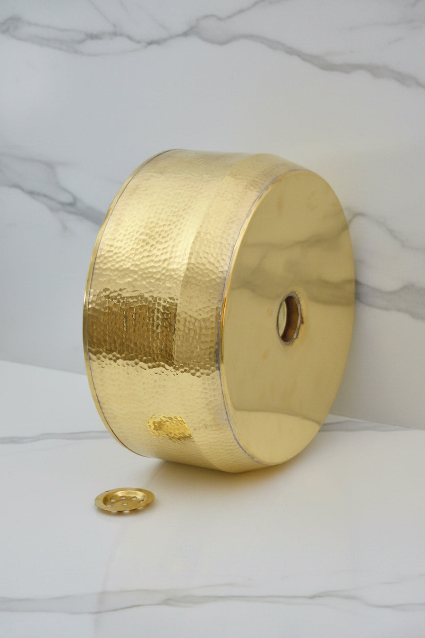 Handmade Hammered Brass Bathroom Sink on a white surface with a tiled wall background