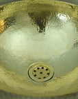 Handmade Hammered Brass Bathroom Sink with a textured surface and central drain.