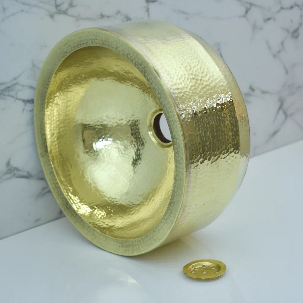 Handmade Hammered Brass Bathroom Sink on a marble surface