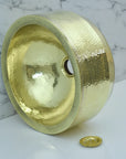 Handmade Hammered Brass Bathroom Sink on a marble surface