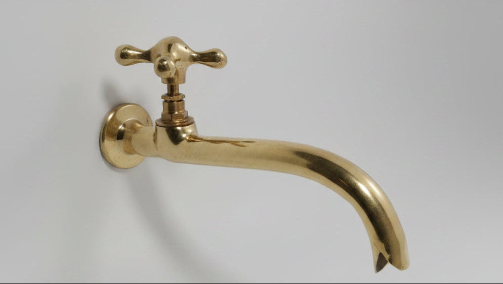 Gold faucet on a white background