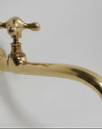 Gold faucet on a white background