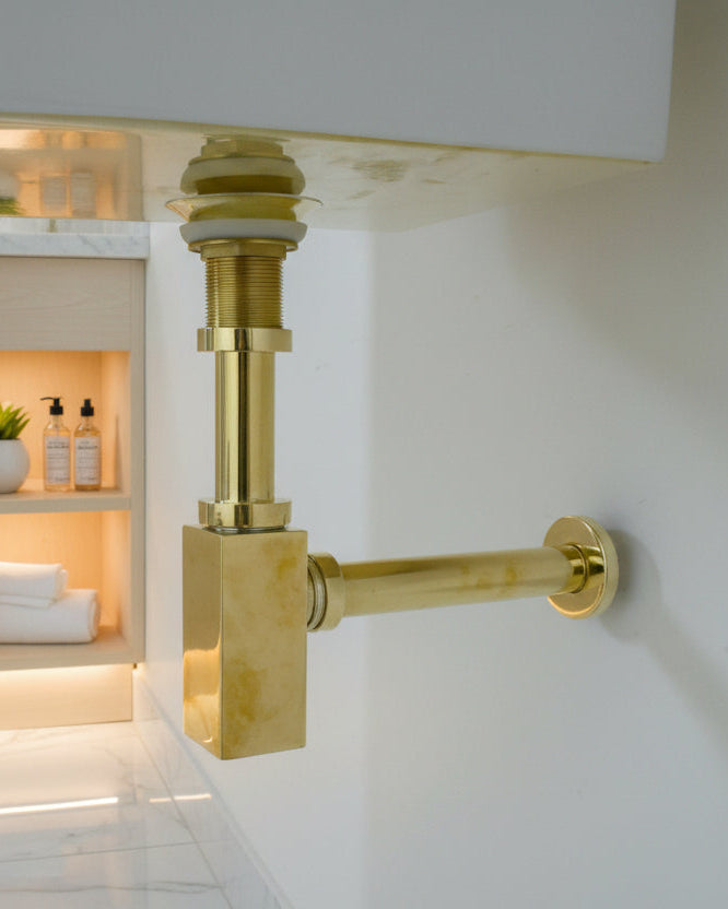 Solid Brass Bathroom Sink P-Trap mounted on a white wall 