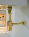 Solid Brass Bathroom Sink P-Trap mounted on a white wall 