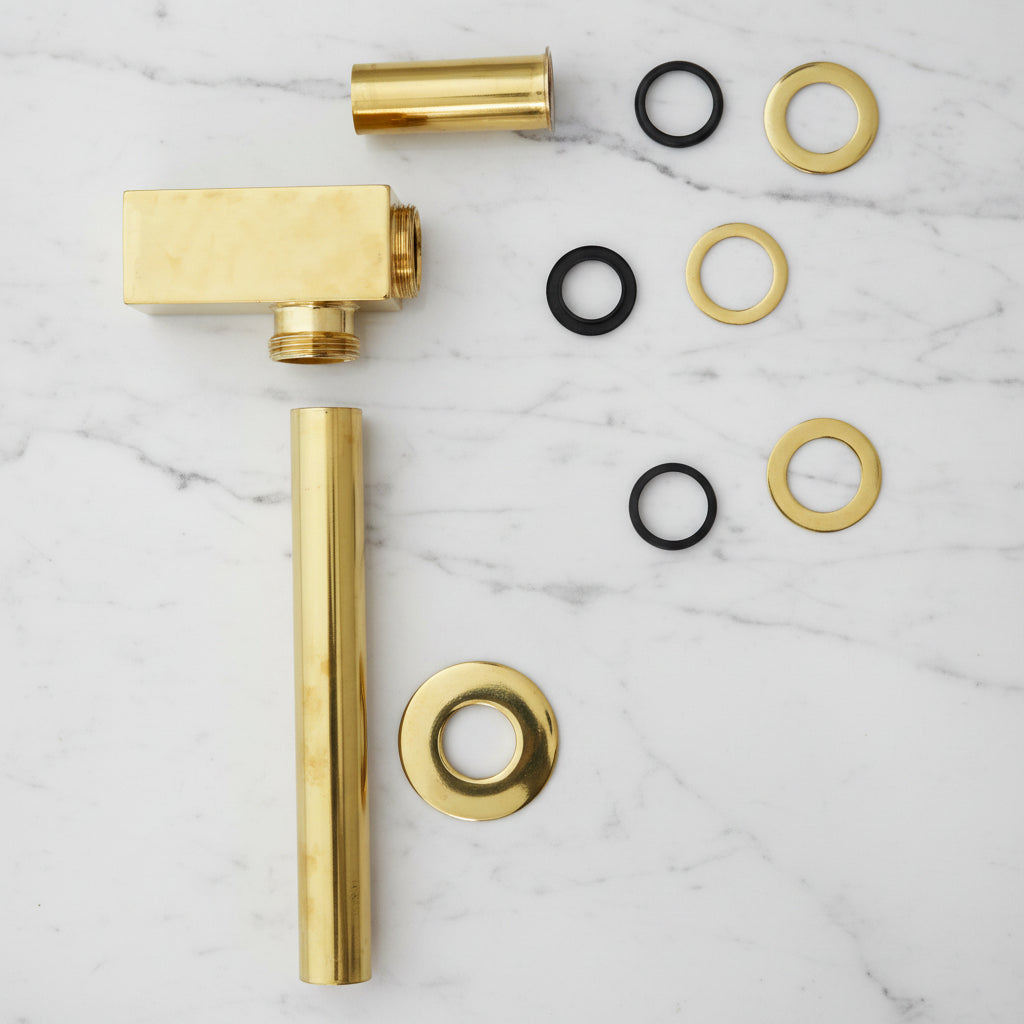 Solid Brass Bathroom Sink P-Trap mounted on a white wall 