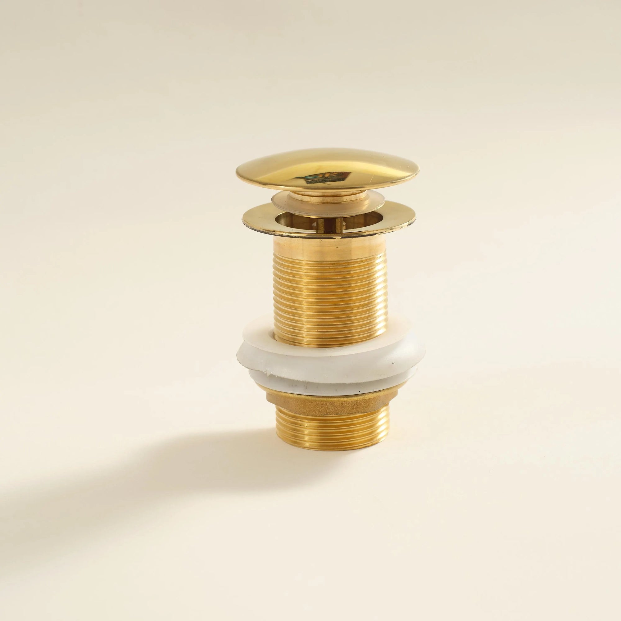 Solid Brass Bathroom Sink P-Trap mounted on a white wall 