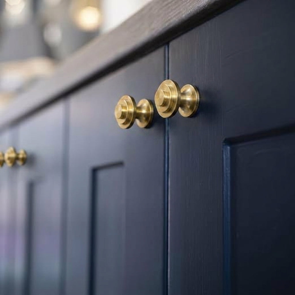Navy blue cabinet with gold knobs