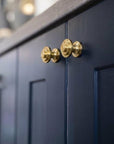 Navy blue cabinet with gold knobs