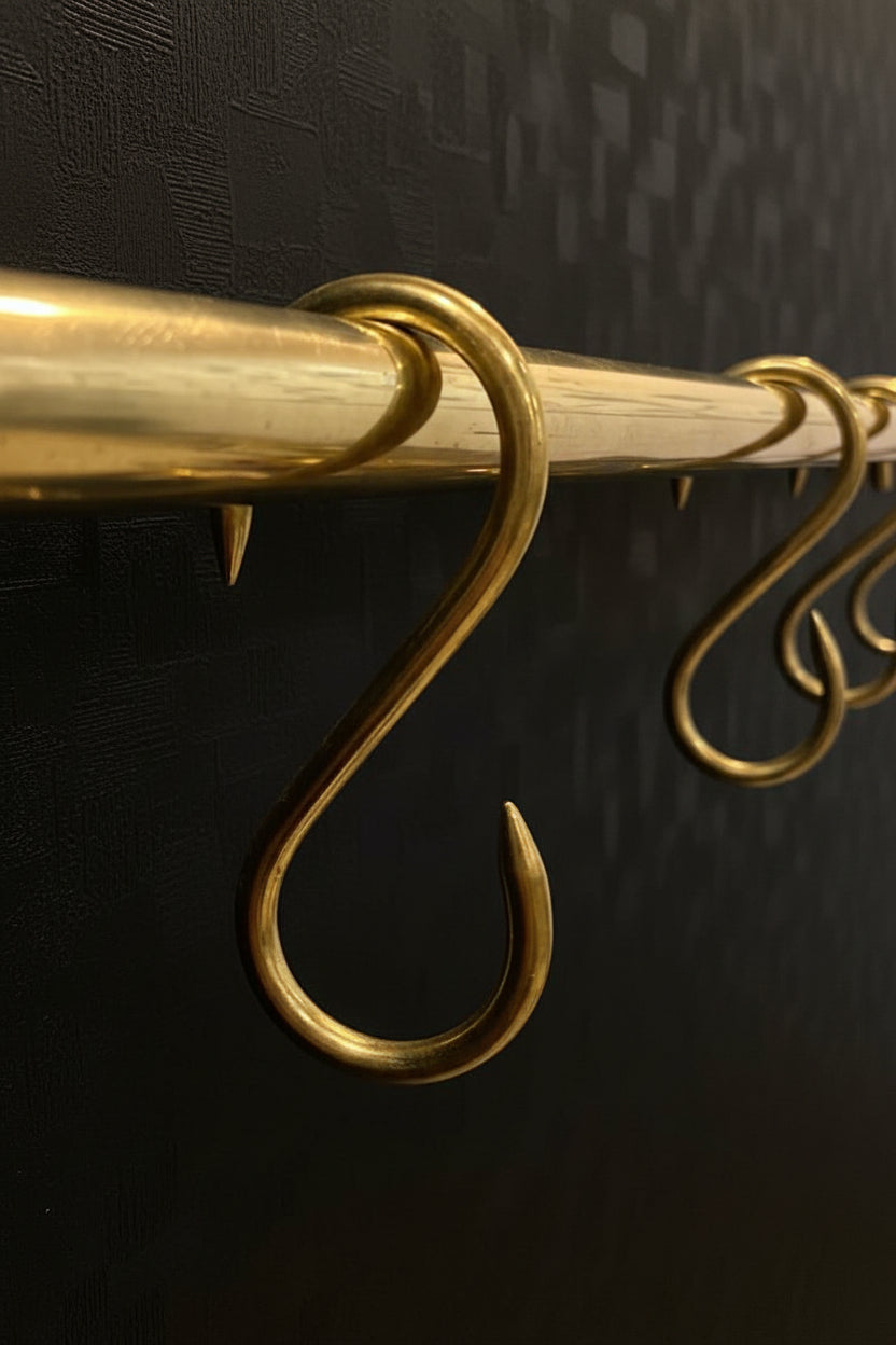 Brass hooks on a black background