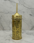 Decorative gold container with intricate patterns on a marble surface