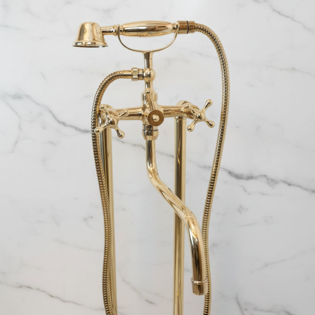 Unlacquered Brass Tub Faucet shower head and hose against a marble wall