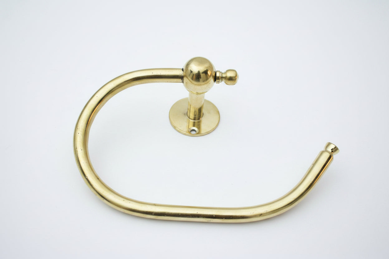 Gold towel ring on a gray surface
