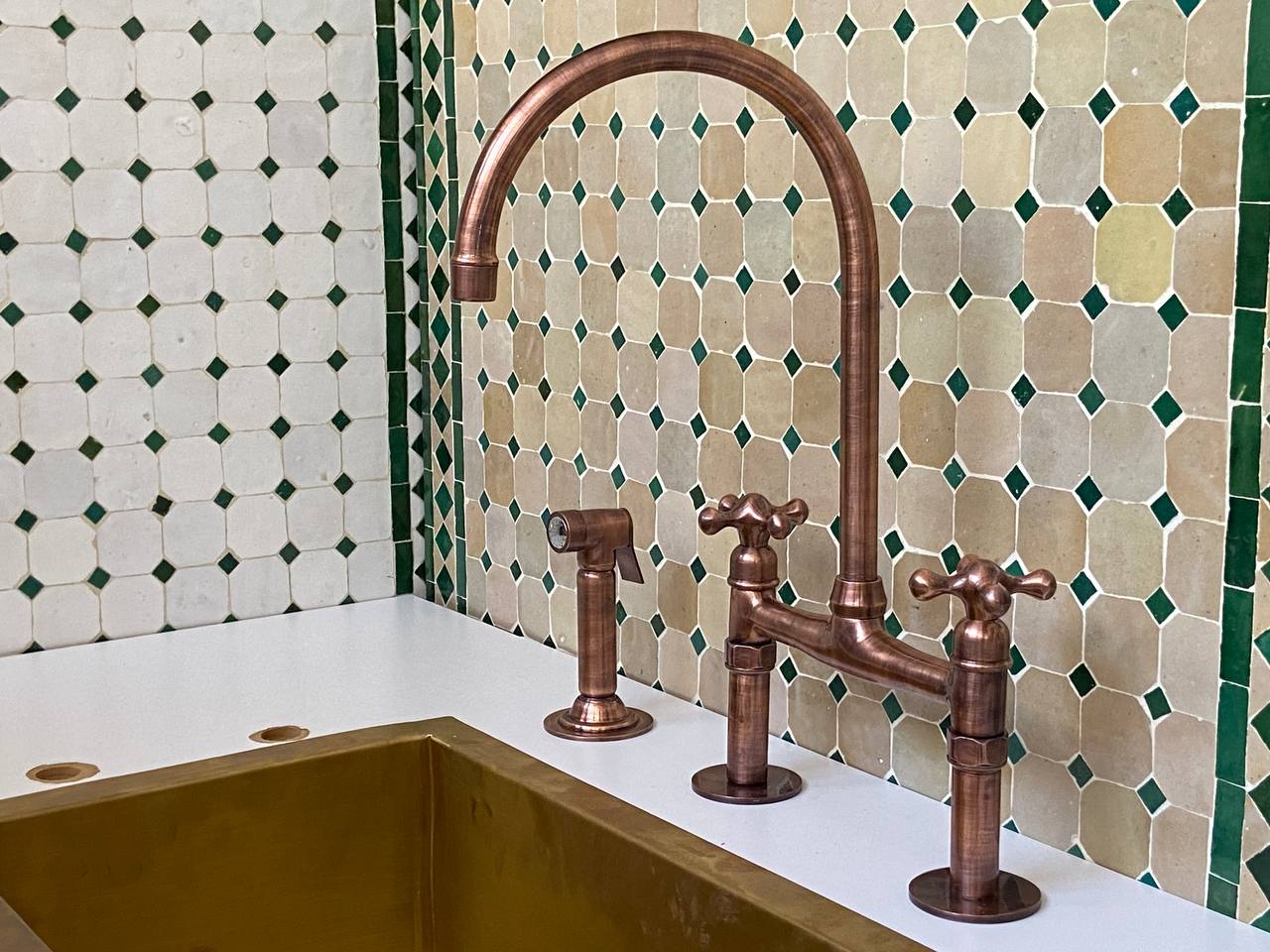Copper kitchen faucet and handles on a tiled wall background